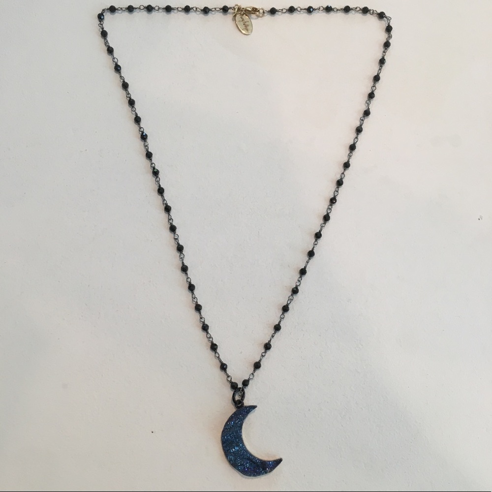 Black beaded necklace with blue moon pendant.